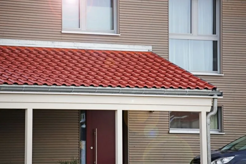 A verandah with a red roofe